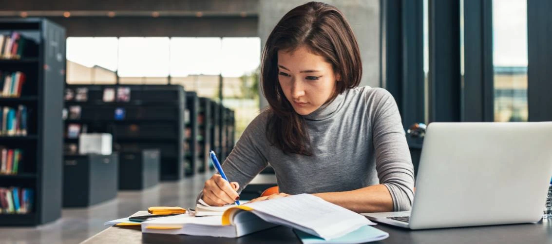 Researcher reviewing an edited academic manuscript with tracked changes